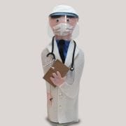 A doctor figurine wearing a mask and holding a book.