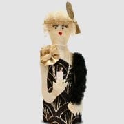 A doll dressed in black and white clothing.