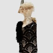 A doll with feathers and black dress