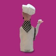 A person wearing an apron and chef 's hat.