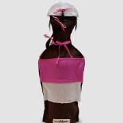 A bottle of wine with a pink and white apron on it.