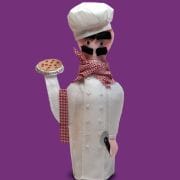 A chef statue holding a pizza on top of his hand.