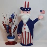 A statue of uncle sam holding an american flag.